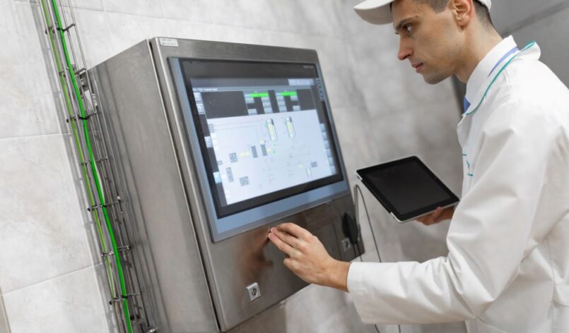 man-in-a-white-robe-and-a-cap-stands-near-the-digi-2025-02-12-22-33-32-utc